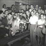 Gino Bartali and crowd watching Lambretta scooter