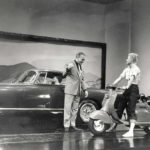James Cagney with the Lambretta 150LD USA next to car